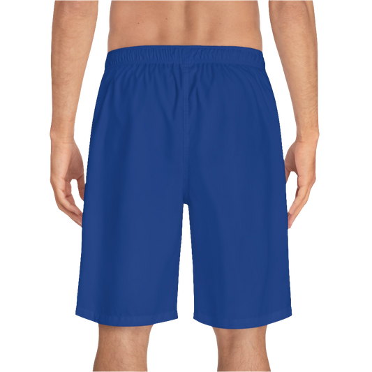 A man wearing pair of dark blue men's board shorts with a small Gymstar logo on the left leg back side view.