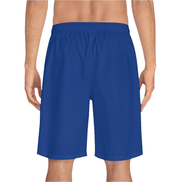 A man wearing pair of dark blue men's board shorts with a small Gymstar logo on the left leg back side view.