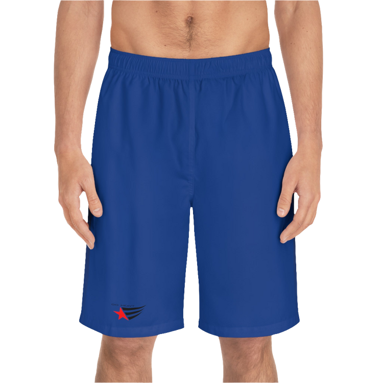 A man wearing pair of dark blue men's board shorts with a small Gymstar logo on the left leg front side view.