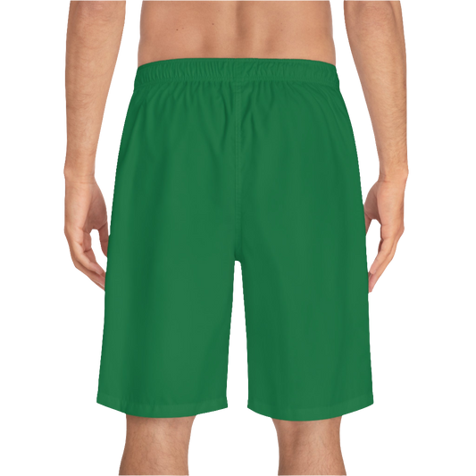 A man wearing pair of green men's board shorts with a small Gymstar logo on the left leg back side view.