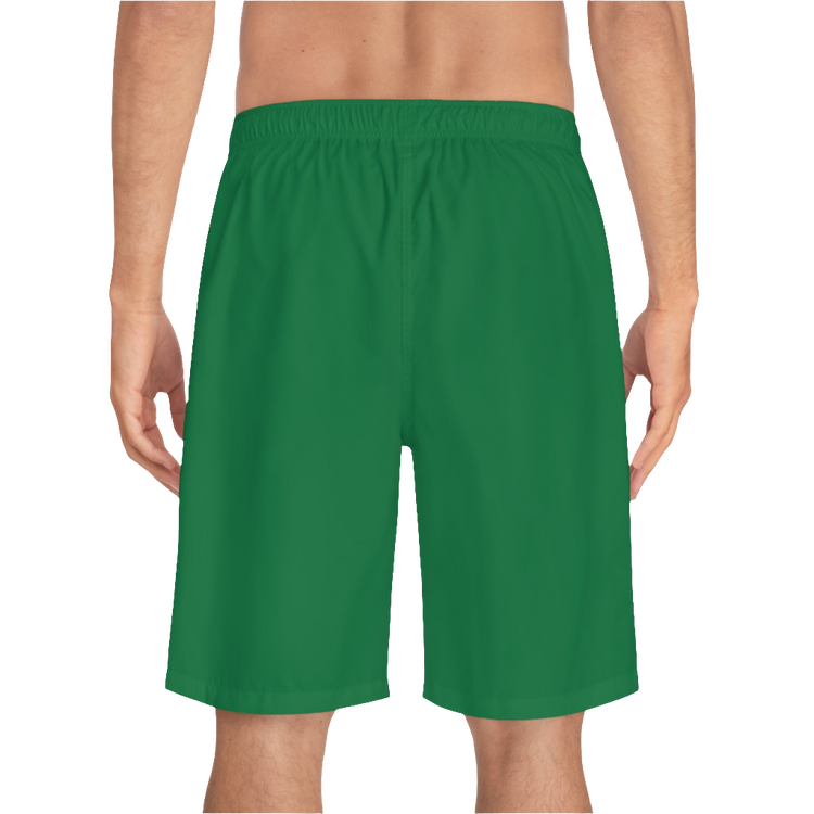 A man wearing pair of green men's board shorts with a small Gymstar logo on the left leg back side view.