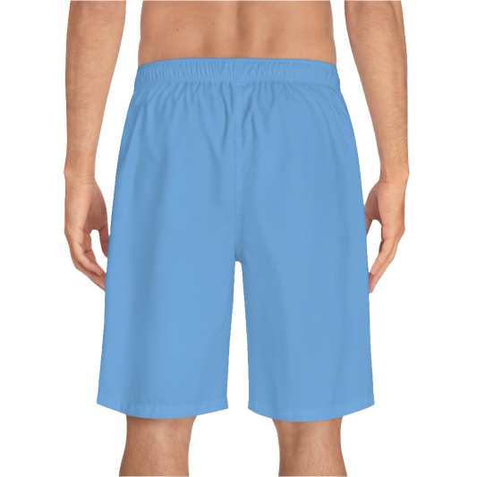 A man wearing pair of blue men's board shorts with a small Gymstar logo on the left leg back side view.