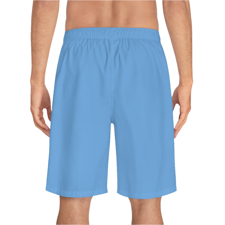 A man wearing pair of blue men's board shorts with a small Gymstar logo on the left leg back side view.