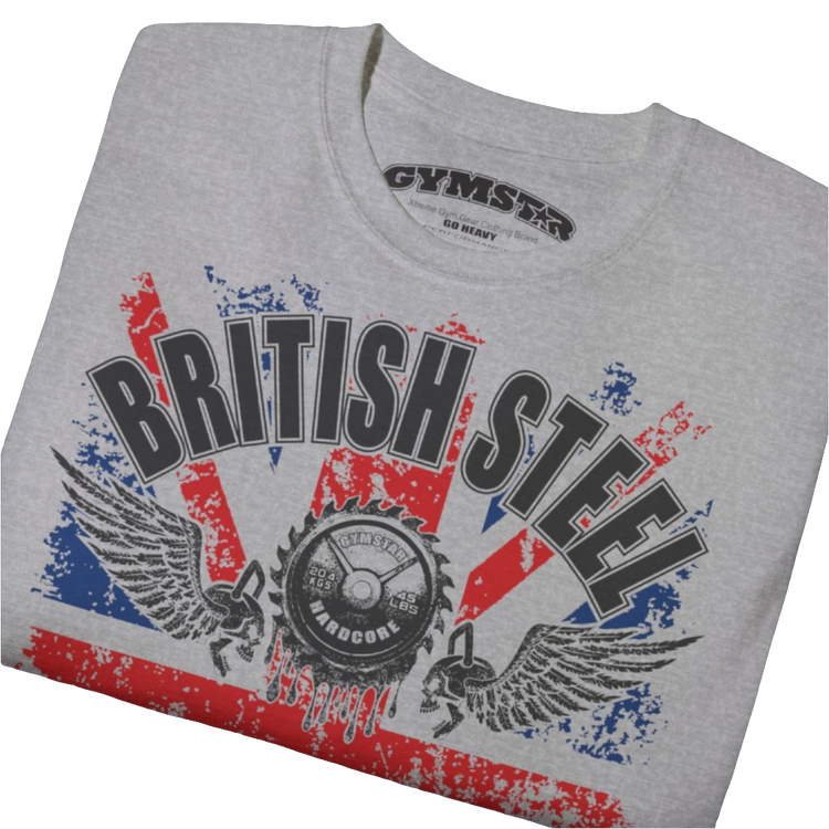 A men's silver grey Gymstar t-shirt featuring a distressed Union Jack flag design. The text "BRITISH STEEL" is arched across the top in blue, with "APOCALYPSTEEL" below it, and "IN THE UK" at the bottom. A stylized circular saw barbel-blade with the words "HARDCORE" is at the center of the design, flanked by two winged, kettlebell-skulls. The overall design has a gritty, bodybuilding aesthetic. Close up view.