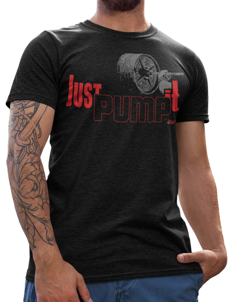 A person with tattoos wearing a black crew neck bodybuilding shirt with the text 'JUST PUMP IT' in red.