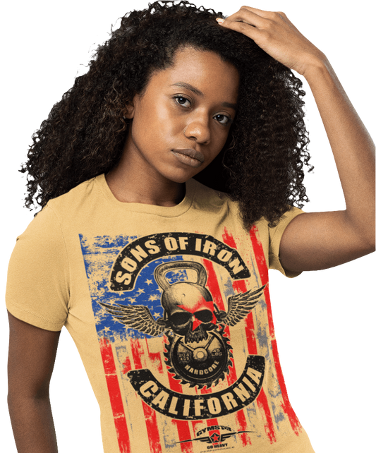 A woman wearing black Gymstar tee with a red, blue and black graphic that reads 'Sons Of Iron', skull-kettlebell, barbell and logo, presumably bodybulding or fitness.