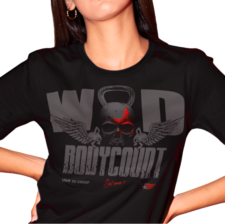 A woman wearing black Gymstar t-shirt, perfect for intense workouts. Made in dark grey with a massive chest print that combines elements like a skull in a kettlebell, spread wings, and a red star. The design is completed with motivational texts "WOD Bodycount", making it an ideal choice for any athlete.
