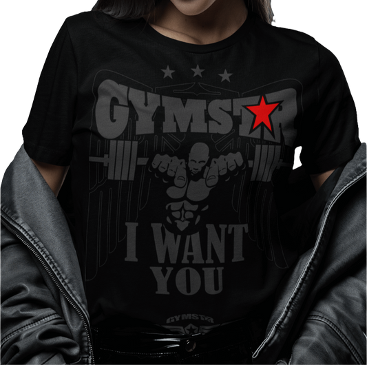 A woman wearing black Gymstar t-shirt with the text 'I WANT YOU' printed on the front, along with graphics of a weightlifter and dumbbells.