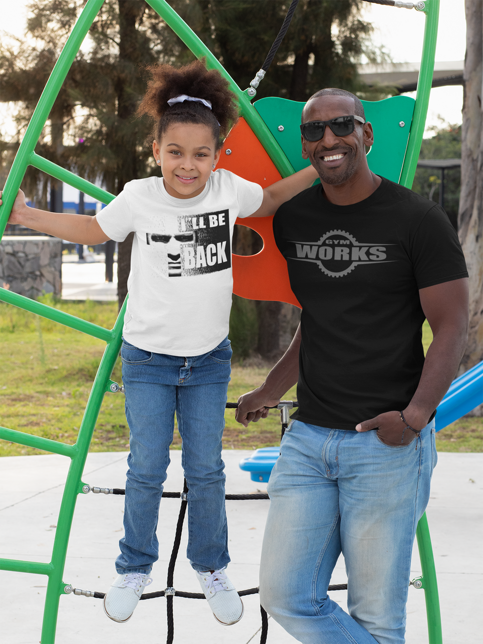 a man wear black gymworks t shirt and a litle girl wear I"l be back t-shirt