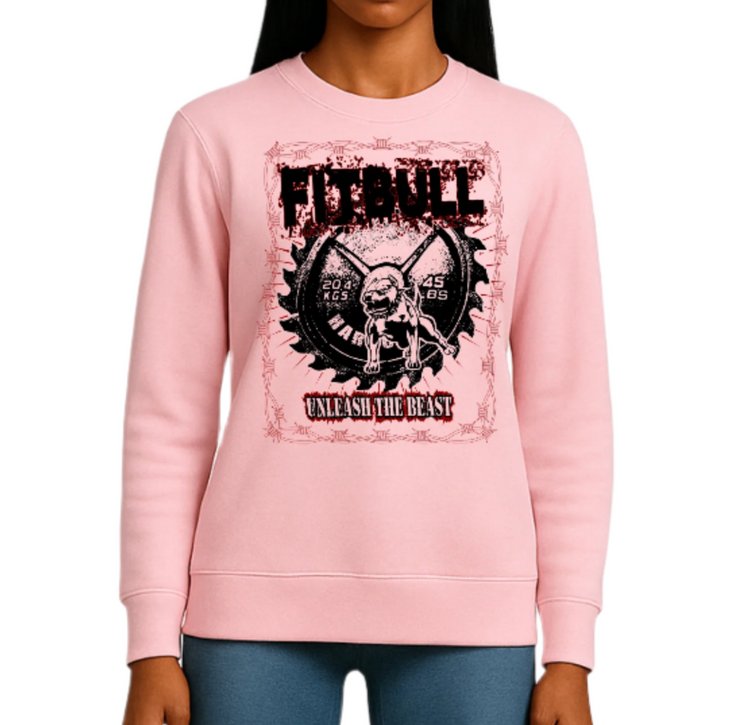 A young woman wearing a pink, Fitbull sweatshirt with a Unleash the Beast 
 graphic design.