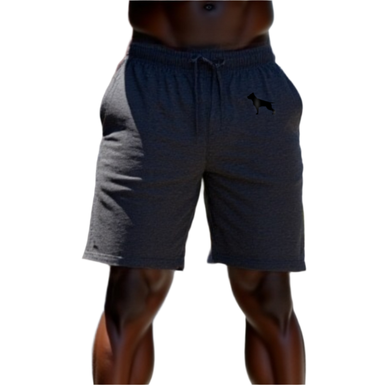 A part of the body of a muscular man shows us blue sports shorts of the sportswear brand Fitbull, with the company's logo.