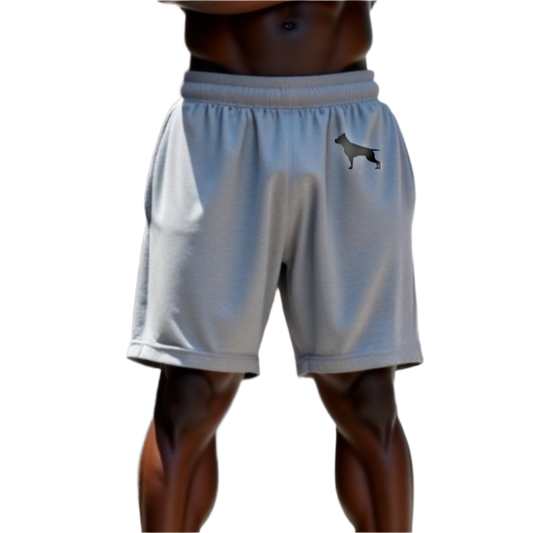 A part of the body of a muscular man shows us white sports shorts of the sportswear brand Fitbull, with the company's logo.