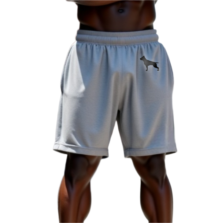 A part of the body of a muscular man shows us white sports shorts of the sportswear brand Fitbull, with the company's logo.