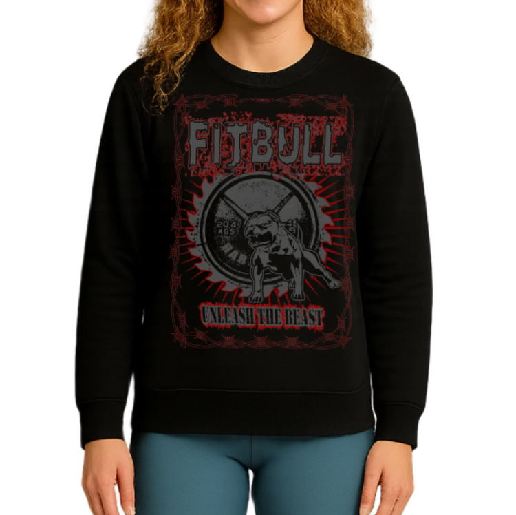 A youn woman wearing a black fitbull sweatshirt with a Unleash The Beast  graphic design and blue leggings.