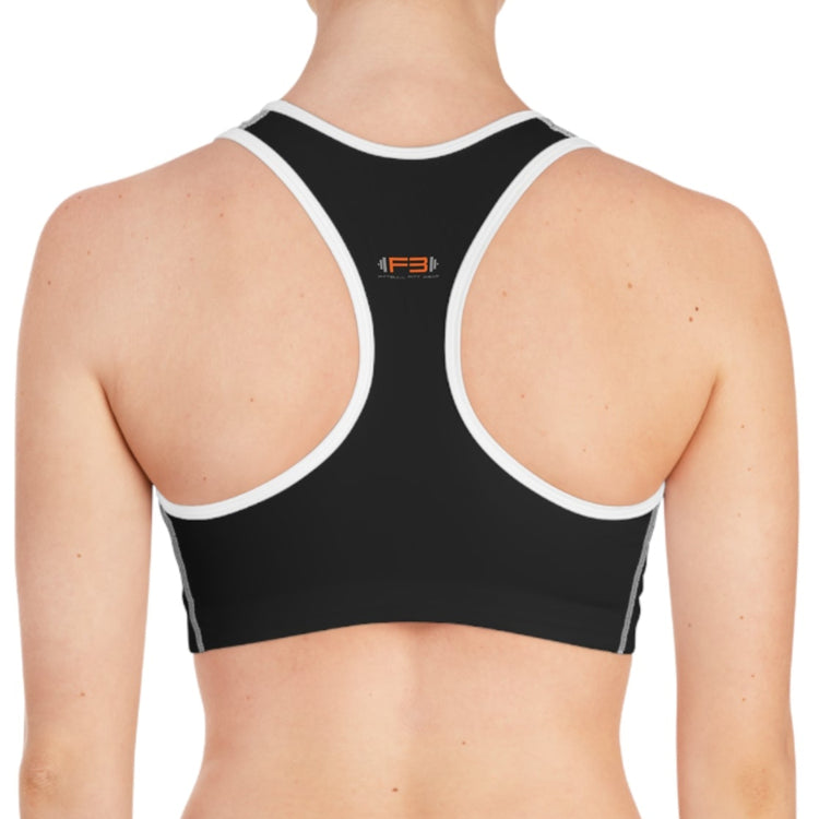 young woman posing for a photo with a black-white fitness bra from Fitbullfit wear