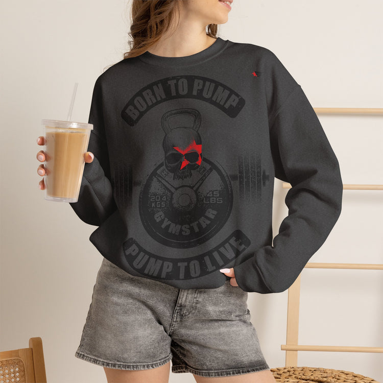 Person wearing a black sweatshirt with a graphic design and text, holding a drink.