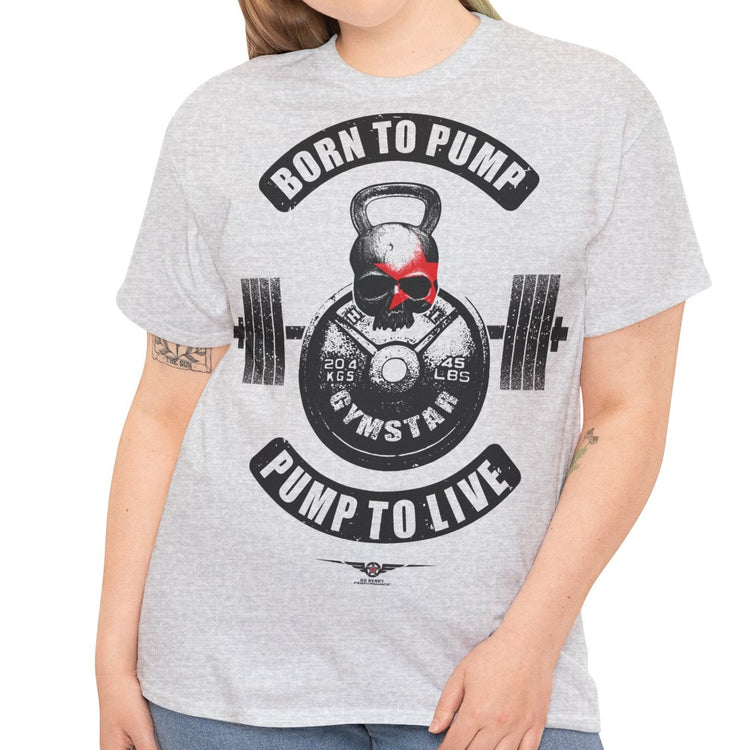 A woman modeling a light heather gray t-shirt with a black and red gym-themed graphic that reads 'BORN TO PUMP' and 'PUMP TO LIVE' around a kettlebell and barbell design.