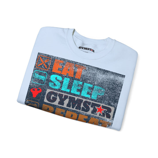 A folded white t-shirt with a colorful graphic print on the front that reads 'EAT SLEEP GYMSTAR REDUCE' in orange, teal, and black distressed lettering, shown on a white background.
