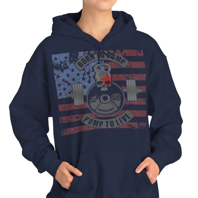 A woman modeling a black pullover hoodie with a distressed American flag graphic on the chest featuring a weight plate and the text 'ROCK YOURSELF PUMP TO LIFE'.