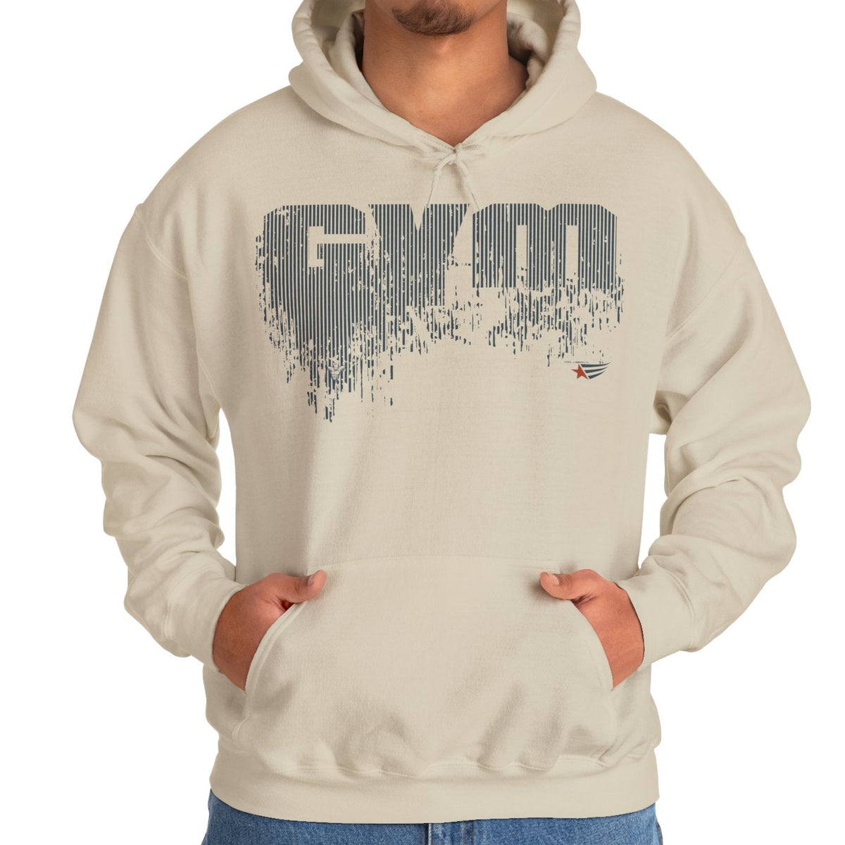 A man wearing a light beige hoodie with a dark gray pixelated 'GYM' graphic on the chest, standing against a plain white background.