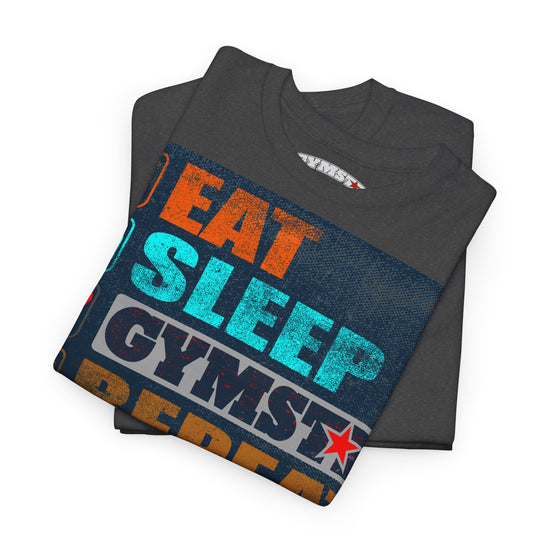 A folded dark gray t-shirt with a colorful graphic print reading 'EAT SLEEP GYMSTRE' in orange, teal, and white text, displayed on a clean white background.