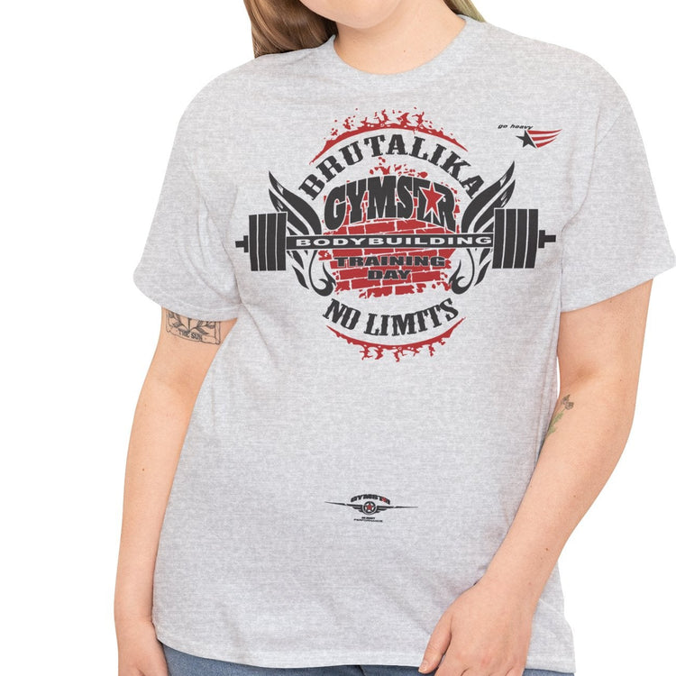A woman modeling a light heather gray graphic t-shirt with a red and black 'Shut Up & Calculate Gymnastics No Limits' design on the front, paired with blue jeans against a plain white background.