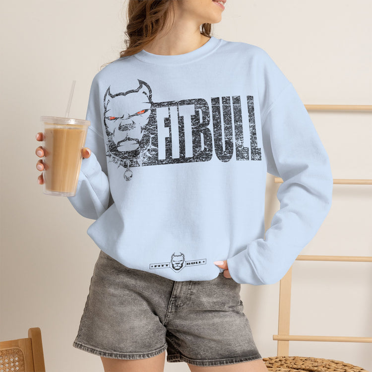 Person wearing a light blue Fitbull sweatshirt with 'FitBull' graphic design, holding a drink.