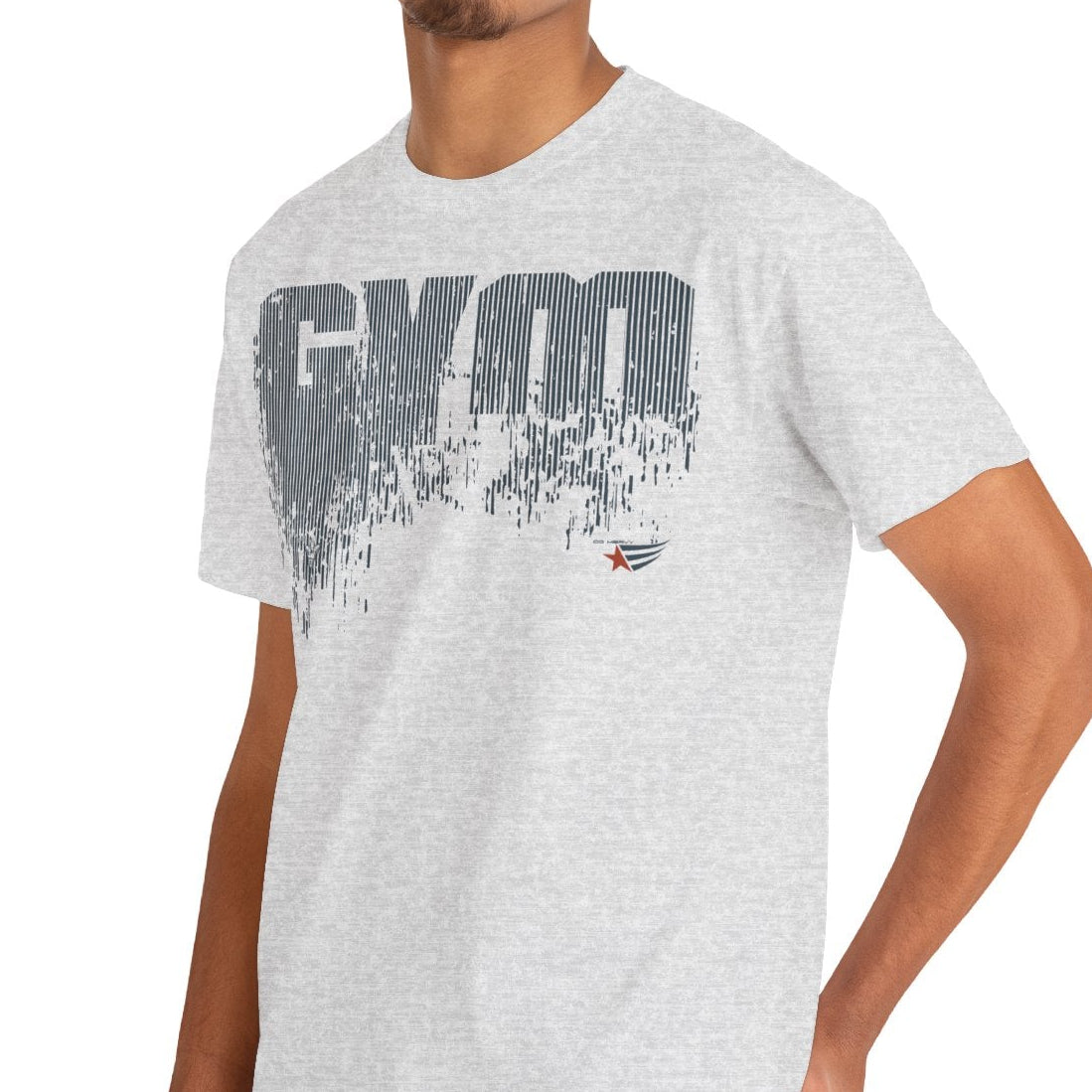 A man wearing a light heather gray t-shirt with a distressed dark gray 'GYM' graphic on the chest, paired with blue jeans, set against a plain white background.