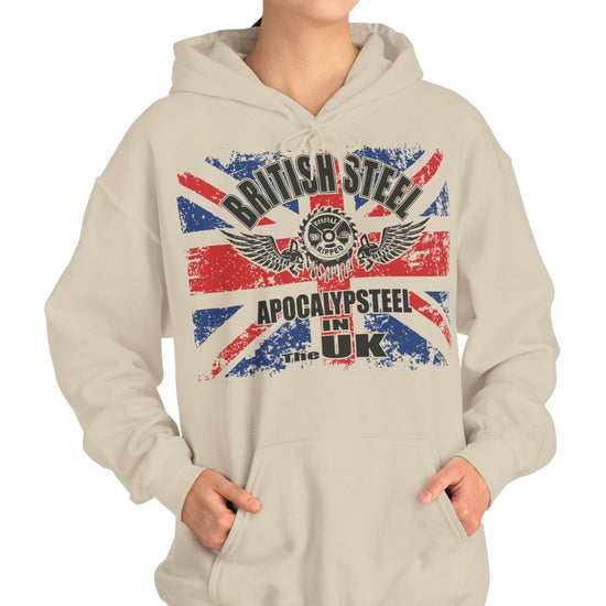 A woman modeling a light beige hoodie with a distressed Union Jack graphic on the front featuring the text 'BRITISH STEEL' and 'APOCALYPSTEEL IN THE UK'.
