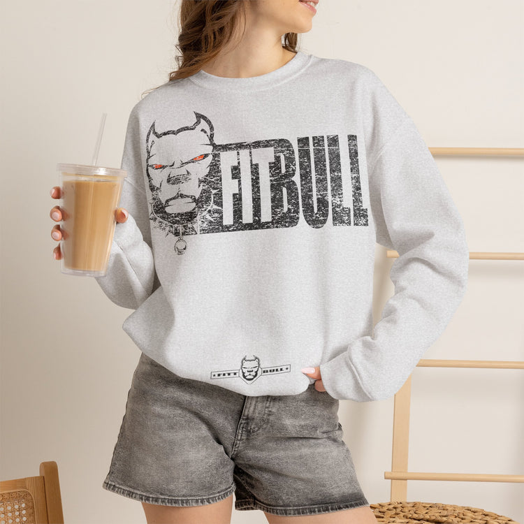 Person wearing a gray FITBULL sweatshirt with 'Fitbull' logo holding a drink.