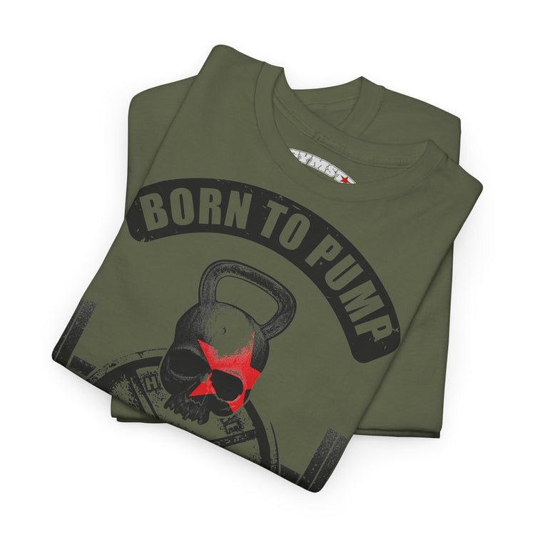 An olive green folded t-shirt featuring a graphic of a skull wearing a red star and a kettlebell, with the text 'BORN TO PUMP' in a black arch above it.