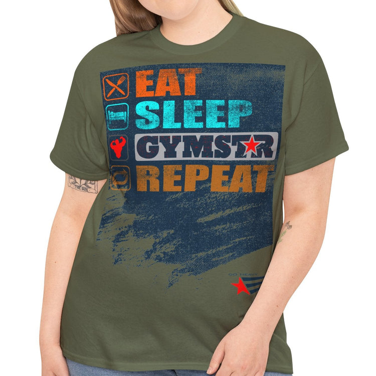 A woman modeling an olive green graphic t-shirt with a distressed blue, orange, and white print that reads 'EAT SLEEP GYMSTAR REPEAT'. She is wearing blue jeans against a plain white background.