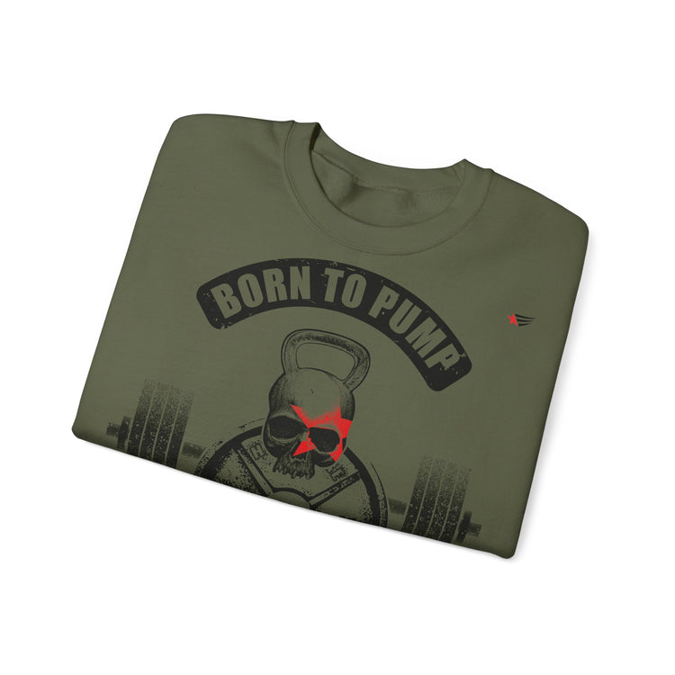 An olive green crewneck t-shirt with a graphic print of a skull wearing sunglasses, a kettlebell, and a barbell, with the text 'BORN TO PUMP' arched above. The shirt is shown folded on a plain white background.