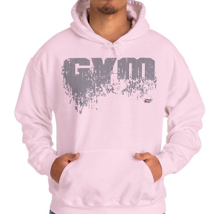 A man wearing a light pink pullover hoodie with a distressed gray 'GYM' graphic on the chest, posed against a solid white background.