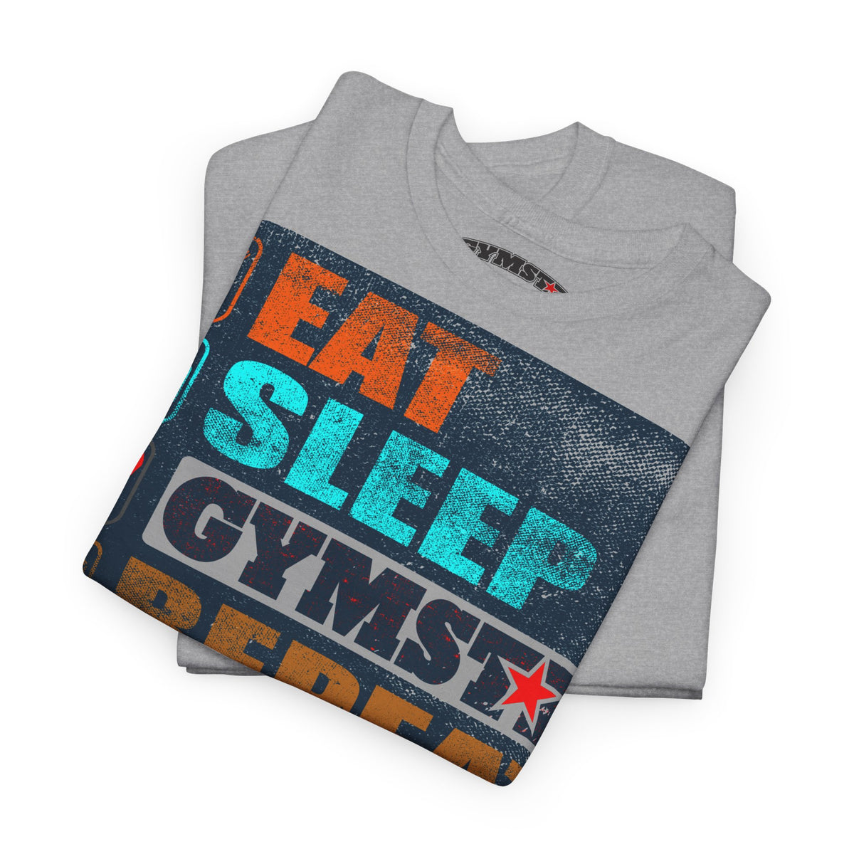 A folded heather gray t-shirt with a colorful graphic print reading 'EAT SLEEP GYMST' in orange, teal, and dark blue text over a distressed dark blue background, on a white studio background.