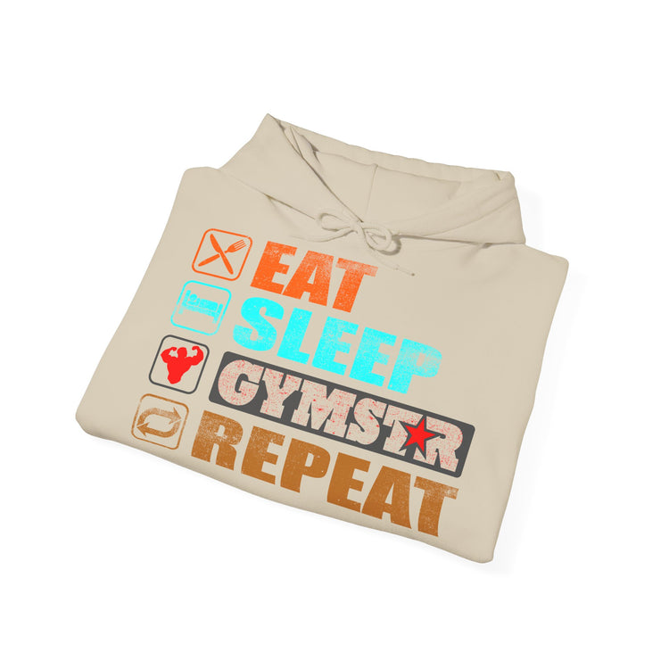A folded beige hoodie on a white background, featuring a colorful graphic print that reads 'EAT SLEEP GYMSTAR REPEAT' with fitness-themed icons.
