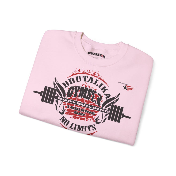 A light pink crewneck sweatshirt folded neatly on a white background, featuring a bold black and red graphic print on the front with the words 'BRUTALIKA GYMSEX', 'GOD BUILDING DAY', and 'NO LIMITS' alongside a barbell design.