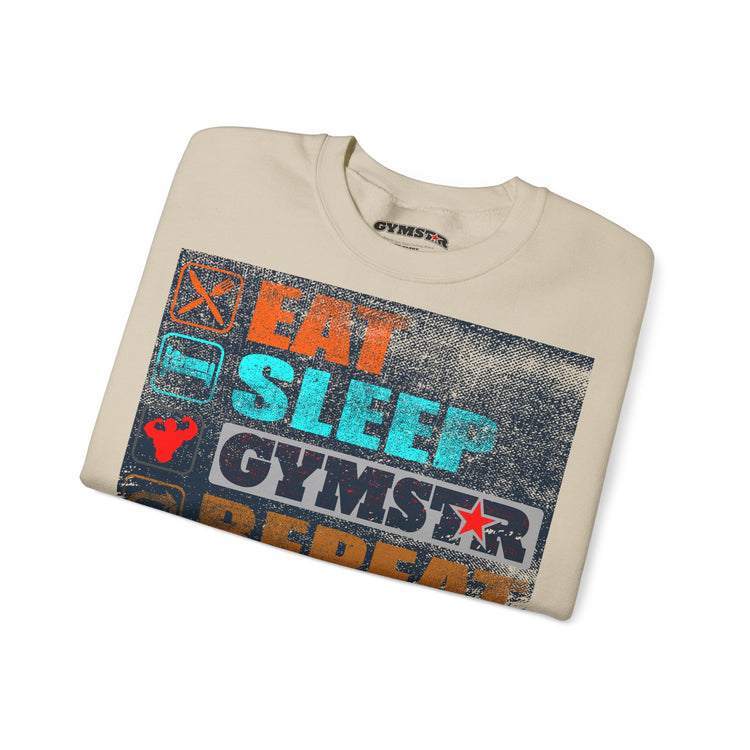 A folded beige crewneck t-shirt with a distressed graphic print on the front that reads 'EAT SLEEP GYMSTAR' in orange, teal, and white, with a gym star logo. The brand name 'GYMSTAR' is visible on the inner neck label and within the graphic.