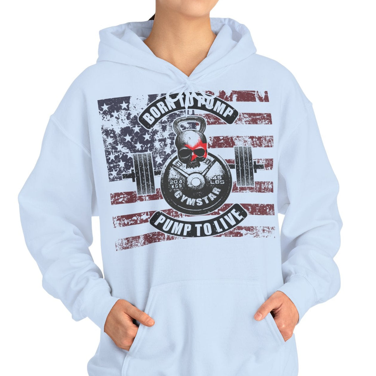 A woman modeling a light blue pullover hoodie with a large patriotic graphic on the front featuring an American flag, a weight plate, and the text 'ROCK THE BUMP CLIMP TO LIFE'.