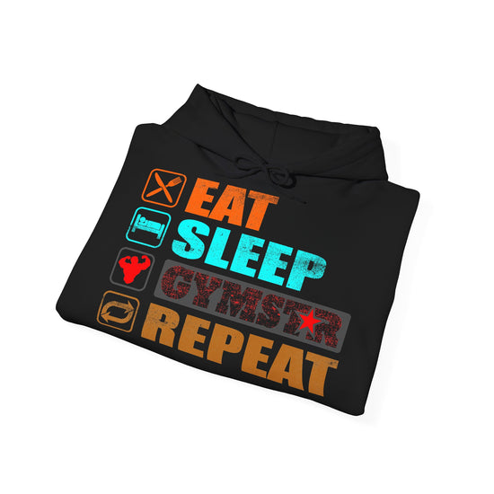 A black hoodie folded and shown from above on a white background, featuring a colorful graphic print with the words 'EAT SLEEP GYMSTER REPEAT' and small fitness-themed icons.
