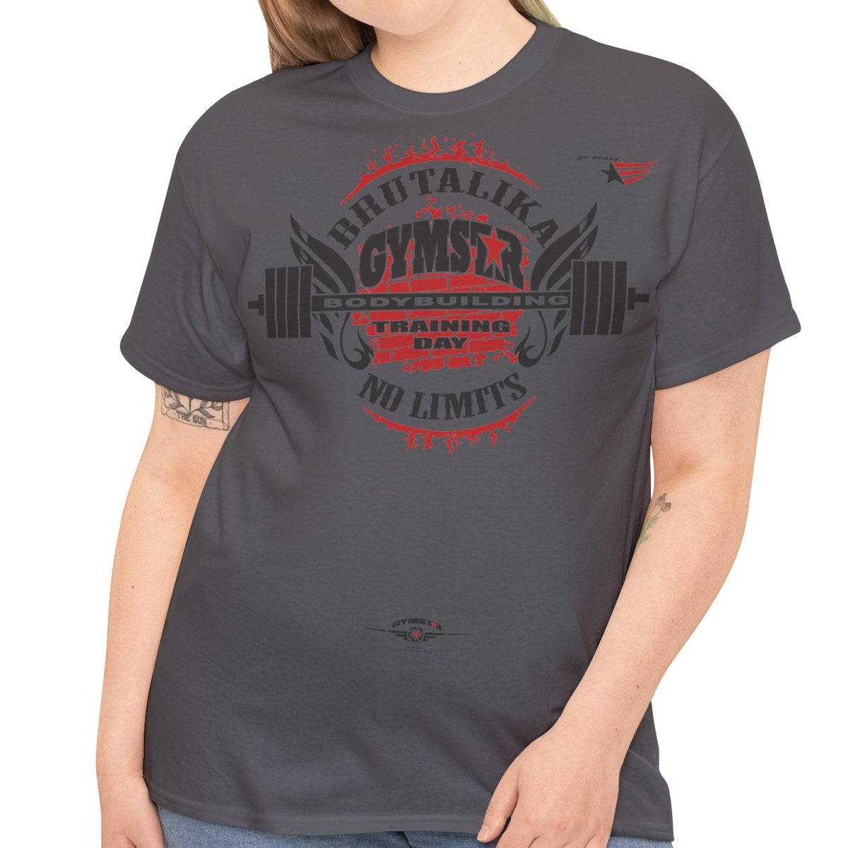 Person wearing a gray t-shirt with 'Jesus Loves You and I'm Trying' text on a white background