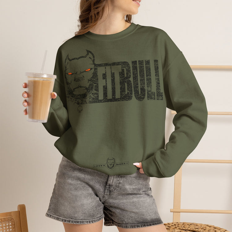 Person wearing a green sweatshirt with 'FITBULL ART' and a nebula design, holding a drink.