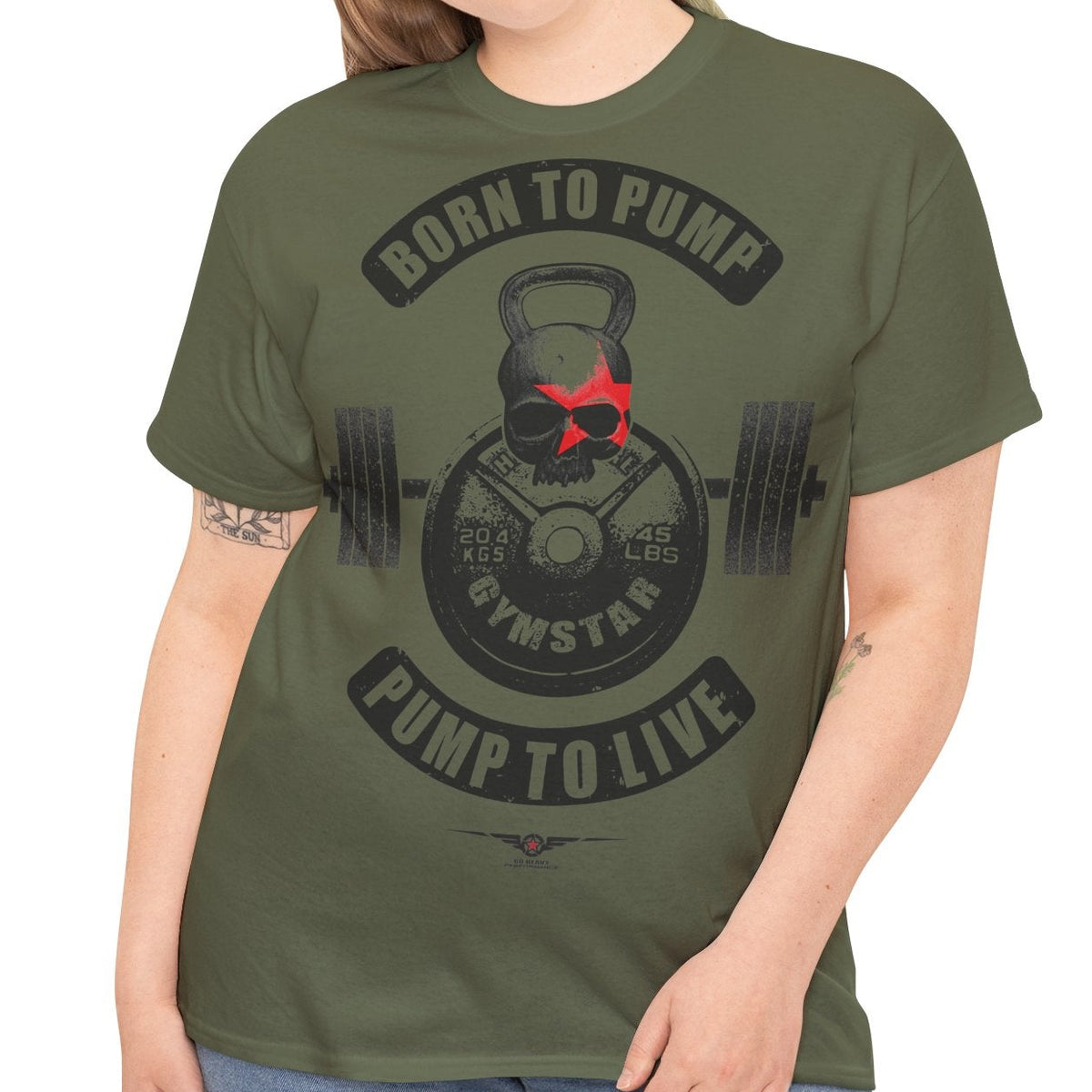 A woman modeling an olive green graphic t-shirt with a black and red gym-themed print that reads 'BORN TO PUMP' and 'PUMP TO LIVE'.