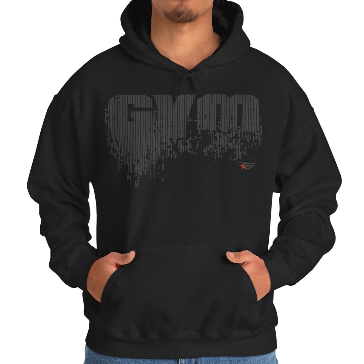 A man wearing a black pullover hoodie with a distressed gray 'GYM' graphic on the chest, standing against a plain white background.