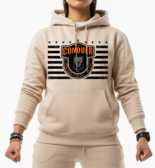Woman wearing a beige Fitbull sporty hoodie with bodybuilding motivating design Conquer with orange accents.