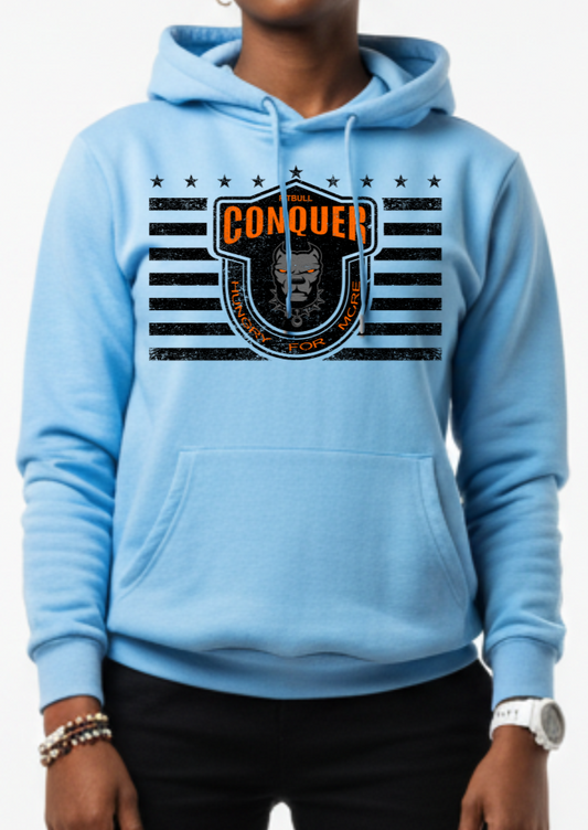 Woman wearing a blue Fitbull sporty hoodie with bodybuilding motivating design Conquer with black accents.