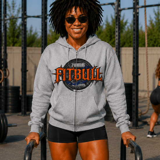 Person wearing a Fitbull hoodie at an outdoor fitness facility.