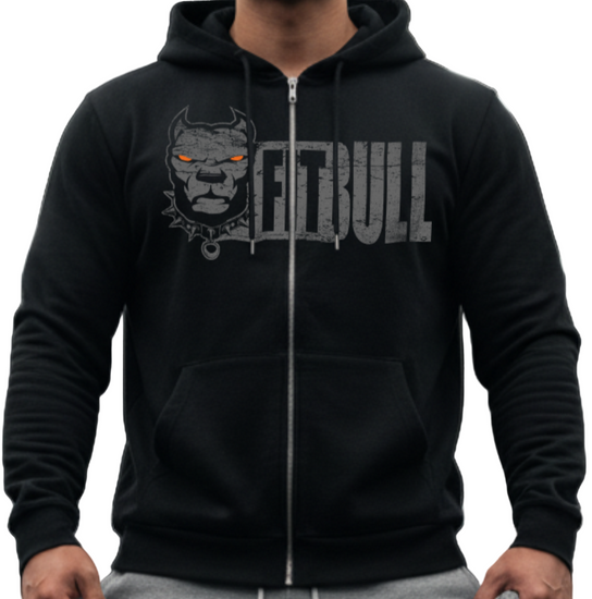 Person wearing a black Fitbull fitness hoodie with a logo and text, gray pants, and red sneakers in a gym setting.