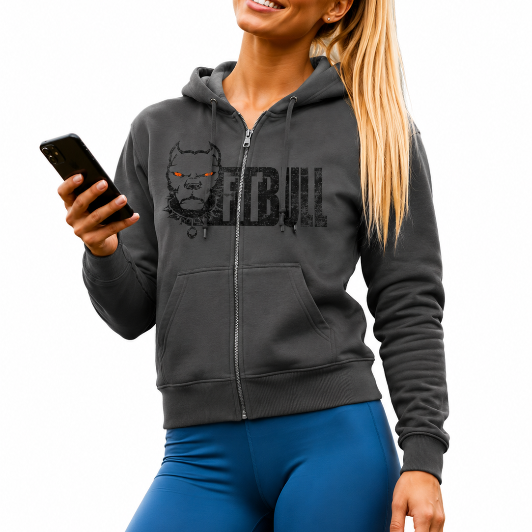 Woman wearing a dark gray Fitbull hoodie with a logo and text, holding a phone, on a white background