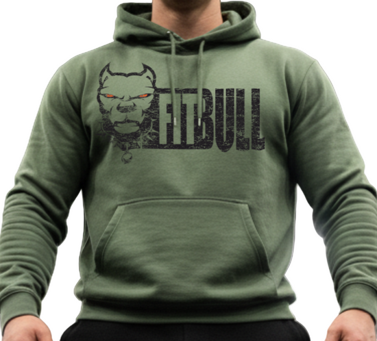 Man wearing a green Fitbull hoodie with a logo in a gym setting